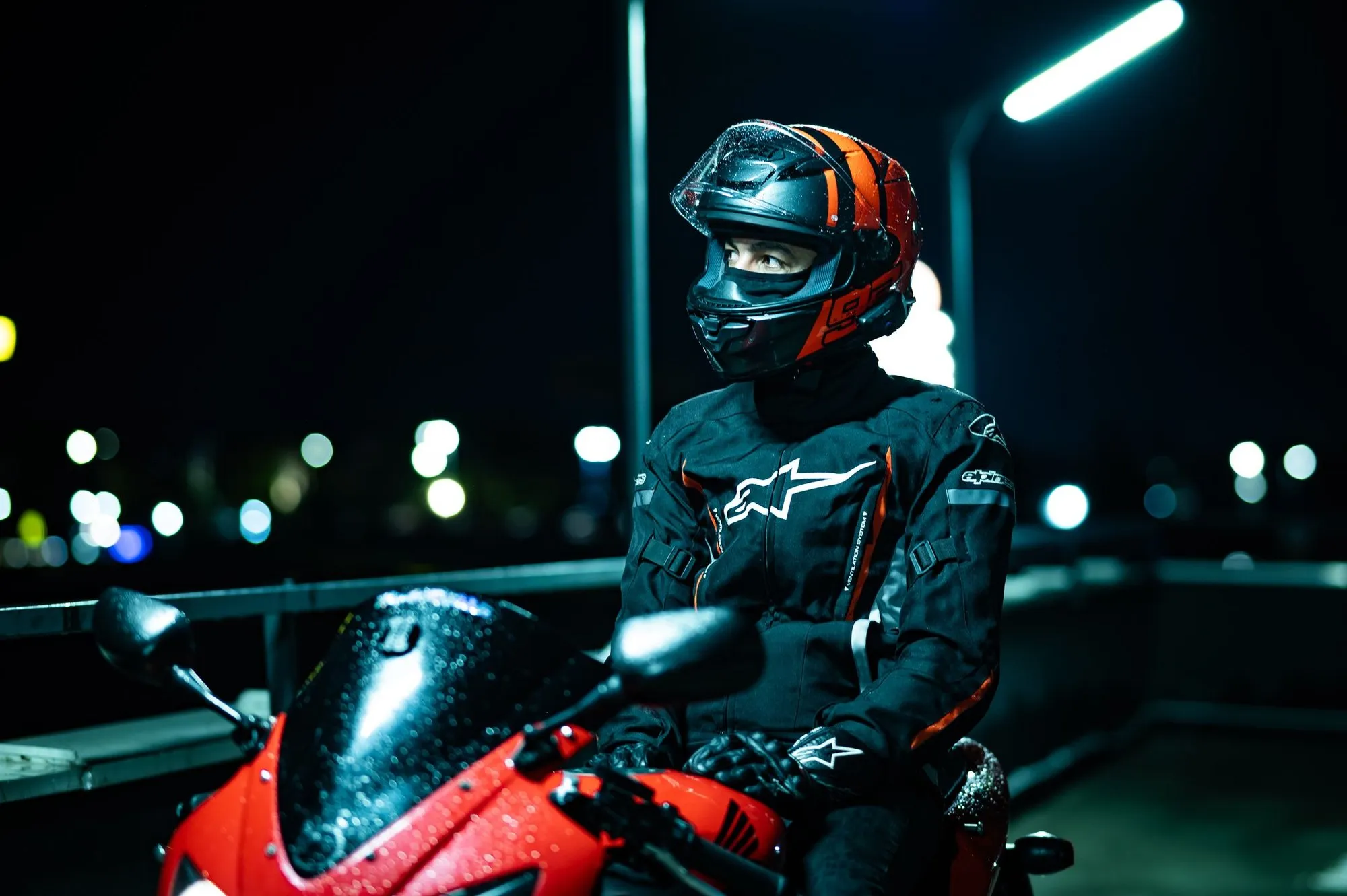 A motorcycle rider in reflective gear at night